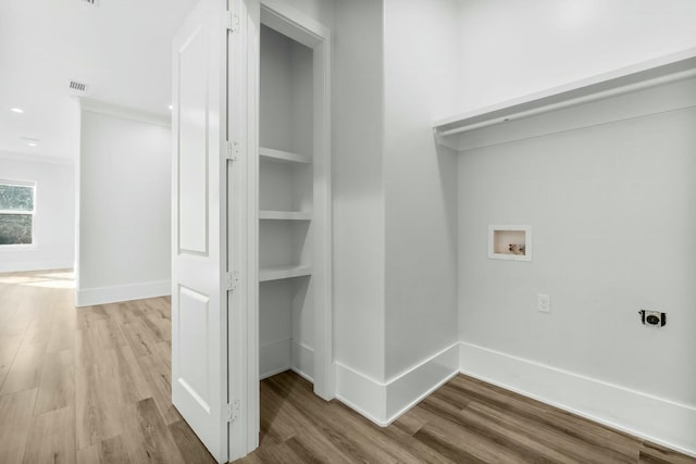 washroom featuring washer hookup, hookup for an electric dryer, baseboards, and wood finished floors