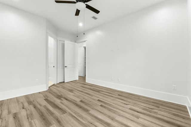 unfurnished bedroom with light wood-style floors, baseboards, visible vents, and a ceiling fan