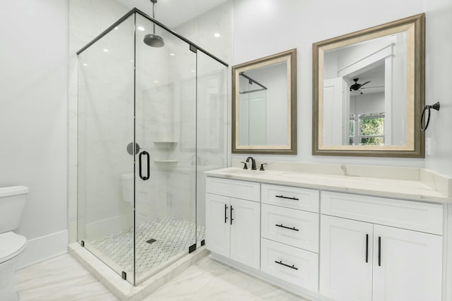 full bath featuring marble finish floor, a stall shower, a sink, and toilet