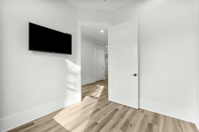 unfurnished room featuring light wood-style floors and baseboards