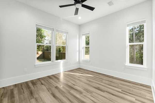 spare room with baseboards, visible vents, a ceiling fan, wood finished floors, and recessed lighting