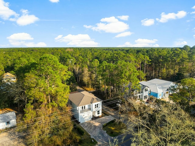 bird's eye view with a wooded view