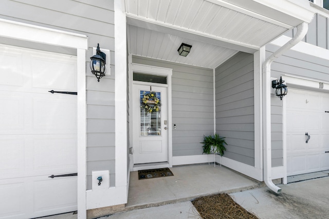 property entrance featuring an attached garage