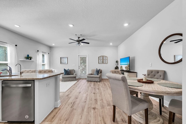 dining room featuring plenty of natural light, light wood-style flooring, and visible vents