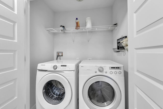 clothes washing area featuring laundry area and washer and clothes dryer