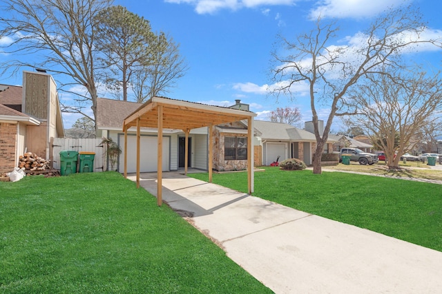 view of front facade with a garage, driveway, a chimney, fence, and a front yard