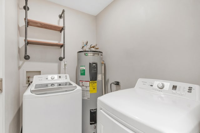 clothes washing area featuring laundry area, independent washer and dryer, and electric water heater