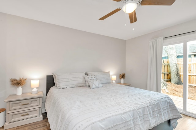 bedroom featuring access to exterior, a ceiling fan, and wood finished floors