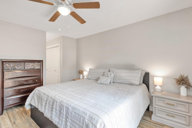 bedroom with ceiling fan, a closet, and light wood-style flooring