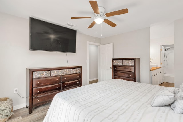 bedroom featuring a ceiling fan, wood finished floors, visible vents, and baseboards