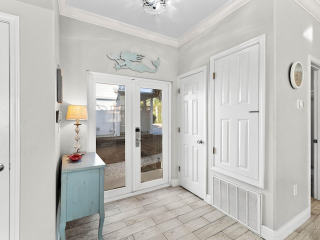 doorway to outside with wood finished floors, visible vents, baseboards, ornamental molding, and french doors