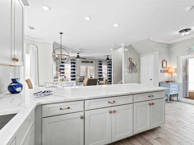 kitchen featuring light wood-style flooring, recessed lighting, a peninsula, visible vents, and crown molding