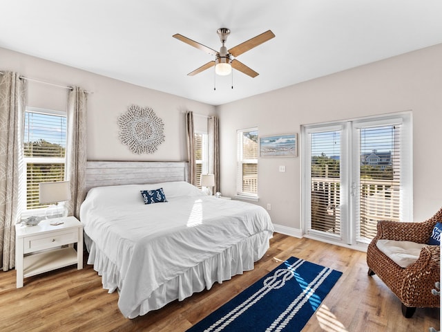 bedroom featuring ceiling fan, access to outside, wood finished floors, and baseboards