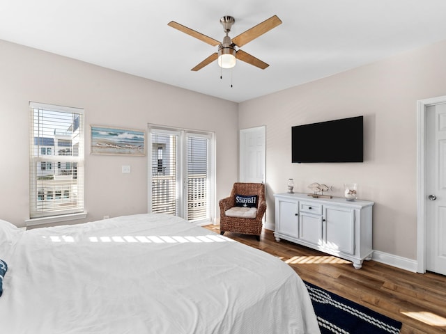 bedroom featuring a ceiling fan, baseboards, and wood finished floors