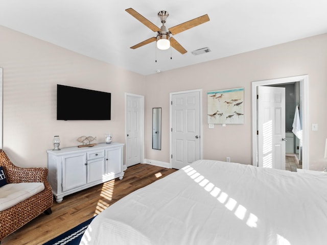 bedroom with visible vents, ceiling fan, baseboards, and wood finished floors