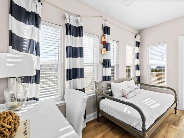 bedroom with wood finished floors and baseboards