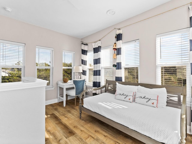 bedroom featuring baseboards and wood finished floors