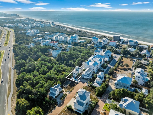 drone / aerial view featuring a beach view and a water view