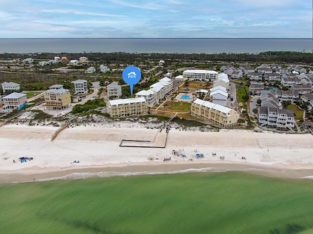 drone / aerial view featuring a water view and a view of the beach