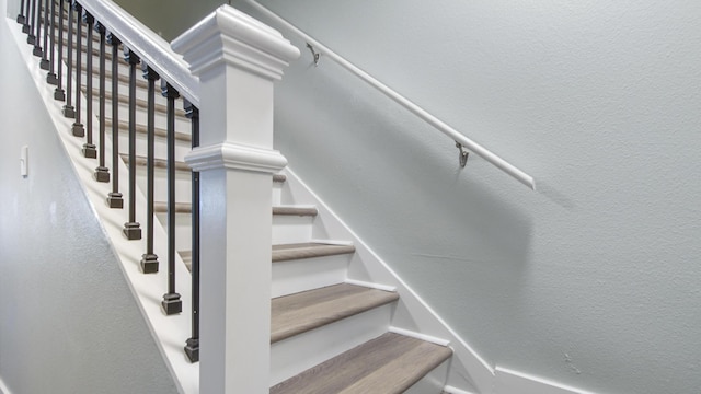 stairway featuring a textured wall