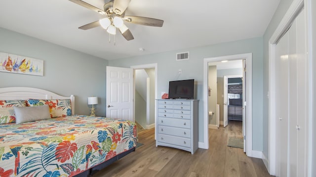 bedroom featuring ceiling fan, visible vents, baseboards, a closet, and light wood-type flooring