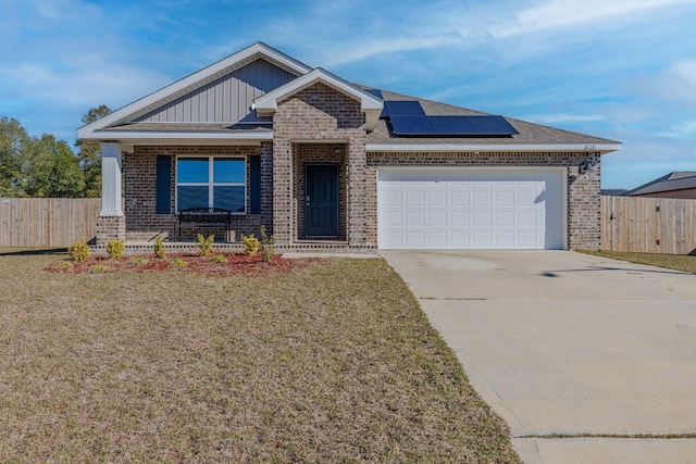 view of front of property with concrete driveway, brick siding, an attached garage, and roof mounted solar panels