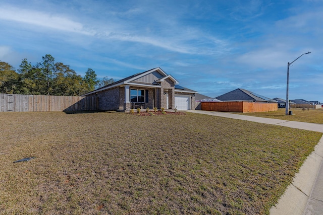 view of front of home featuring a garage, fence, a front lawn, and concrete driveway