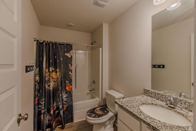 full bath featuring visible vents, toilet, shower / bathtub combination with curtain, a textured ceiling, and vanity