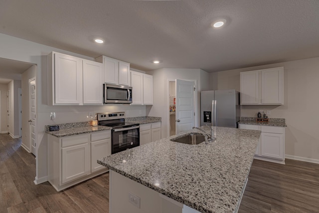 kitchen featuring white cabinets, dark wood-style floors, stainless steel appliances, and a sink