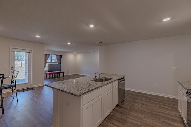 kitchen featuring baseboards, white cabinetry, dark wood-style flooring, and a sink