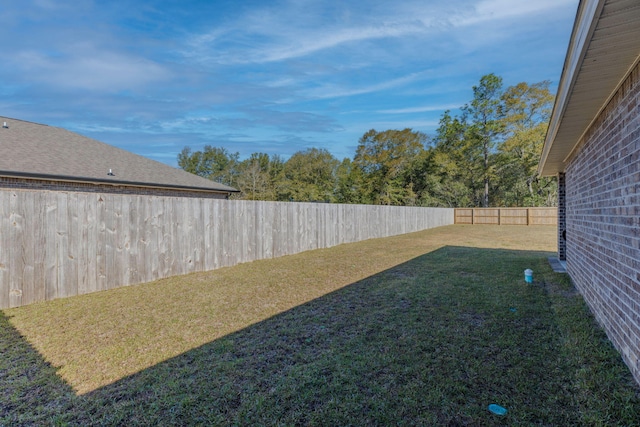 view of yard with a fenced backyard