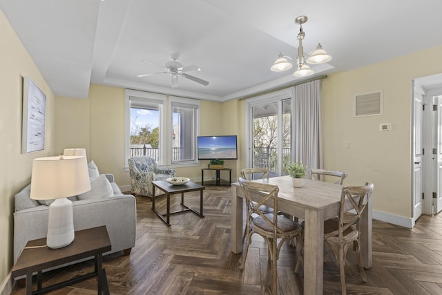 dining room with visible vents, baseboards, and ceiling fan with notable chandelier