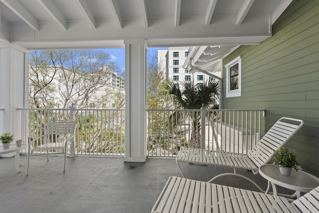 sunroom / solarium featuring beam ceiling