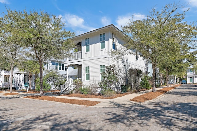 view of property featuring a balcony and board and batten siding