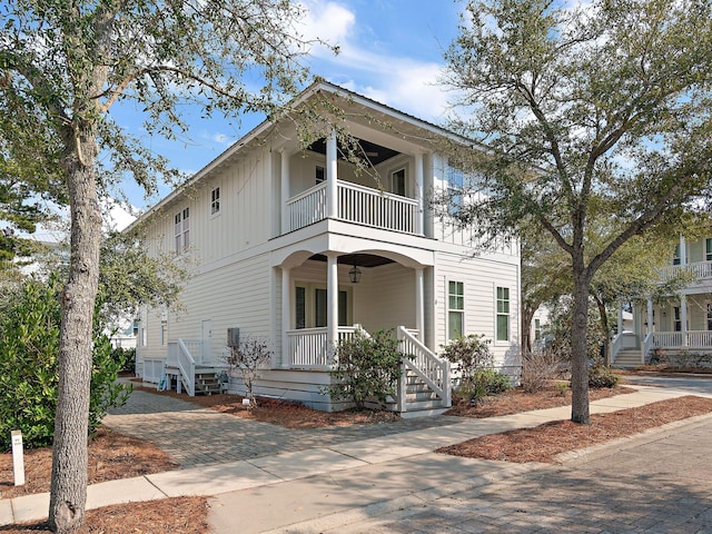 view of front of home with a porch and a balcony