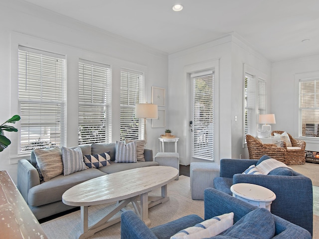 living room with recessed lighting, crown molding, and wood finished floors