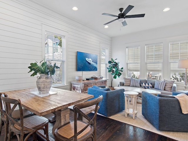 living area featuring wood walls, a ceiling fan, wood finished floors, and recessed lighting