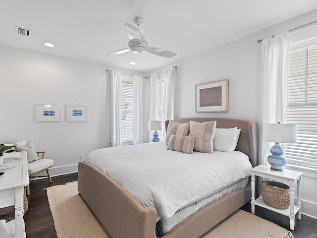 bedroom with recessed lighting, visible vents, dark wood-type flooring, ceiling fan, and baseboards