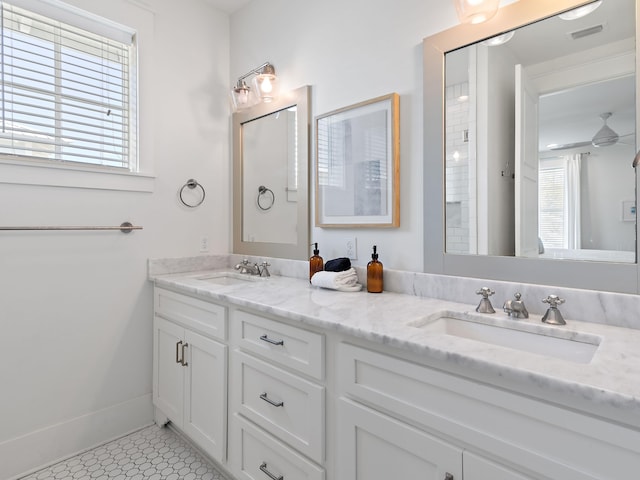 full bathroom featuring ceiling fan, double vanity, a sink, and visible vents