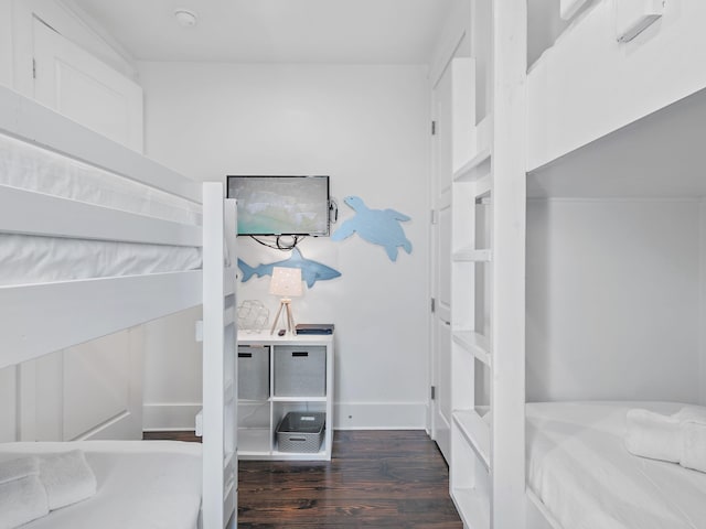 bedroom with baseboards and wood finished floors