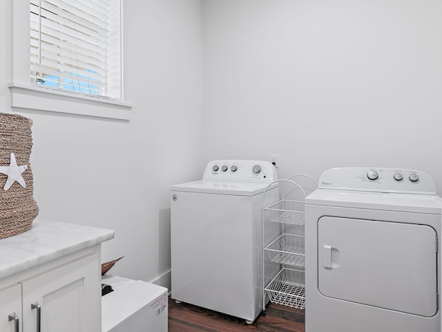 laundry area with dark wood-type flooring, cabinet space, and separate washer and dryer