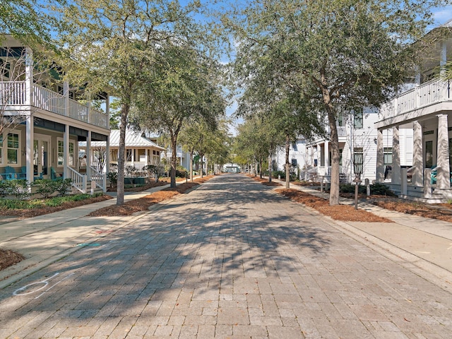 view of street with sidewalks, a residential view, and curbs