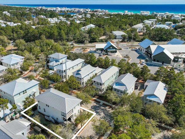 drone / aerial view featuring a residential view and a water view