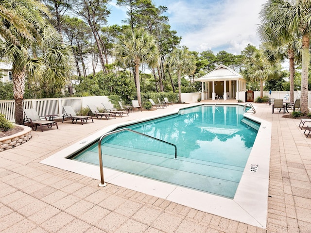 pool featuring a patio area and fence