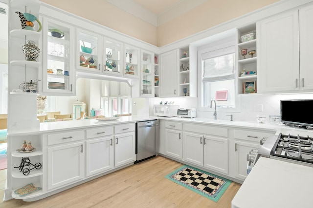 kitchen with light countertops, appliances with stainless steel finishes, light wood-style floors, white cabinets, and open shelves