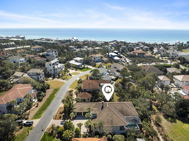 birds eye view of property with a water view and a residential view