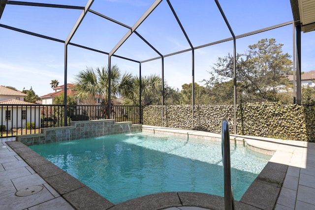 view of swimming pool with glass enclosure, a patio area, and a fenced in pool