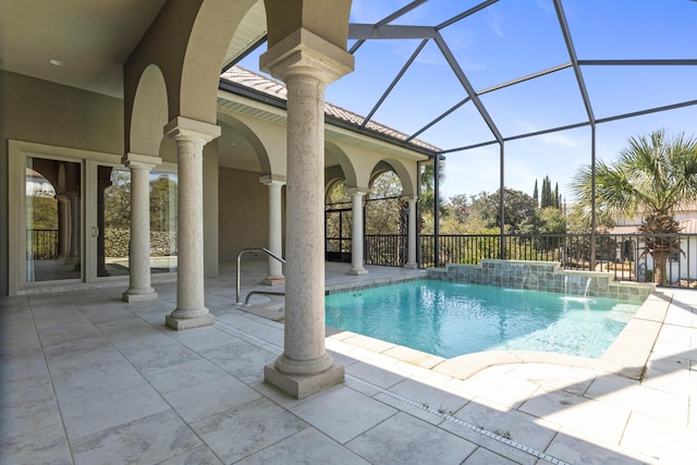 pool featuring glass enclosure and a patio area