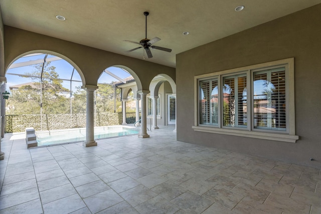 view of patio with a lanai, ceiling fan, and a fenced in pool