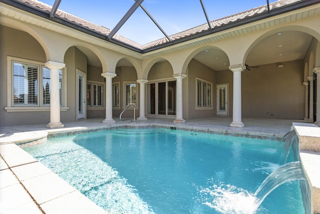 pool with a lanai, a patio, and ceiling fan